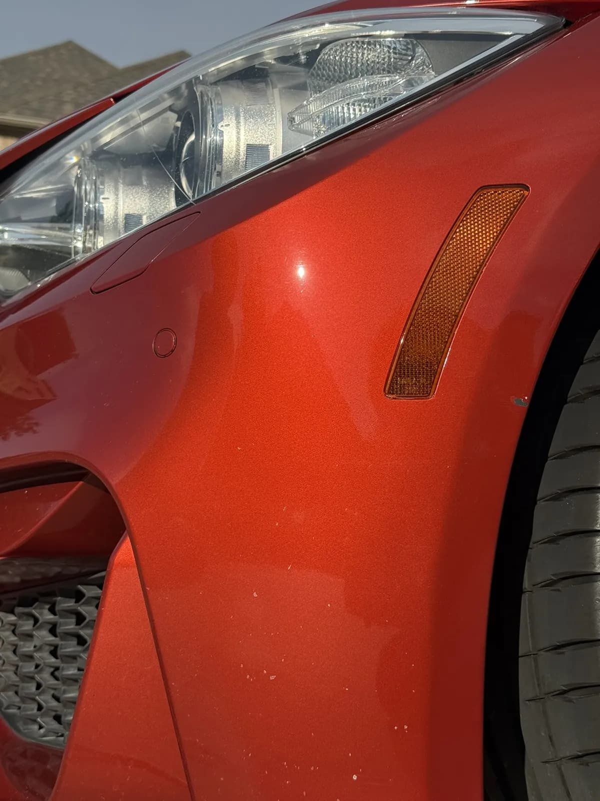 Red sedan photographed by JX Auto Lab